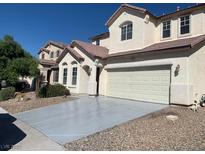 Two-story home features a two car garage, desert landscaping, and neutral paint scheme at 3728 Prairie Orchid Ave, North Las Vegas, NV 89081