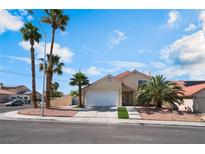 Two-story home with palm trees, a two-car garage, and desert landscaping at 5516 Cory Pl, Las Vegas, NV 89107