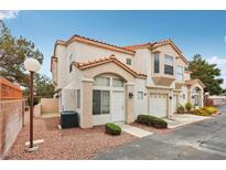 Attractive two-story townhome featuring a red tile roof and stucco exterior, with a one-car garage at 6812 Coral Rock Dr, Las Vegas, NV 89108