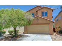 Charming two-story home with a two-car garage and mature tree in the front yard at 7464 Edgecove Ct, Las Vegas, NV 89139