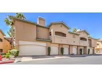 Multi-unit condo complex showing attached garages and stucco exteriors with desert landscaping at 8737 Red Brook Dr # 204, Las Vegas, NV 89128