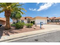 Charming single-story home featuring desert landscaping, a red tile roof and a two car garage at 904 Big Horn St, Henderson, NV 89002