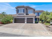Charming two-story home showcasing a three-car garage, neutral paint, and a well-maintained front yard at 93 Autumn Day St, Henderson, NV 89012
