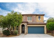 Charming two-story home featuring a tile roof, stone accents, and a blue two-car garage door at 9312 Poseidon Valley Ave, Las Vegas, NV 89178