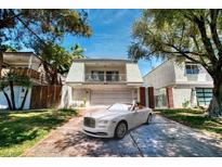 Charming two-story home with a well-manicured front yard and a two-car garage, complete with a luxury car at 940 Vegas Valley Dr, Las Vegas, NV 89109