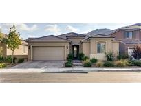 Charming single-story home featuring desert landscaping, a tile roof, and an attached two-car garage at 9537 Wild Valley Ave, Las Vegas, NV 89148