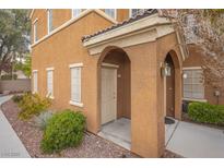 Inviting front entrance featuring a covered porch with stylish arches and attractive landscaping at 10291 Delta View Ct # 101, Las Vegas, NV 89129