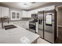 Bright kitchen featuring stainless steel appliances and quartz countertops at 10291 Delta View Ct # 101, Las Vegas, NV 89129