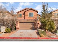 Inviting two-story home features a terracotta facade, well-kept landscaping, and attached two-car garage at 1512 Groom Ave, North Las Vegas, NV 89081