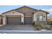 Charming home featuring a three-car garage, low-maintenance landscaping, and a welcoming exterior at 157 Sarabeth St, Las Vegas, NV 89138