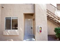 Tan exterior with security door, window, and fire extinguisher box at 2110 Los Feliz St # 1034, Las Vegas, NV 89156