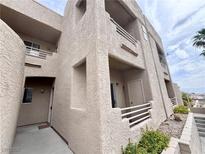 Beige condo building with balconies and tan paint in an outdoor setting at 2160 Highpointe Dr # 102, Laughlin, NV 89029