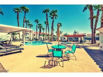 A community pool area with lounge chairs and palm trees offers a relaxing outdoor experience at 2725 S Nellis Blvd # 1037, Las Vegas, NV 89121