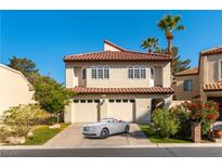Beautiful two-story home with tile roof and a two-car garage and manicured lawn at 2845 Queens Courtyard Dr, Las Vegas, NV 89109