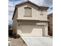 Inviting two-story home featuring a neutral color, attached garage, and low maintenance landscaping at 3644 Starlight Evening St, Las Vegas, NV 89129