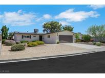 Charming single-story home with a two-car garage, well-kept landscaping, and a sunny sky at 415 Emerald Cir, Henderson, NV 89002