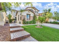 Beautiful two-story home with a lush green lawn and meticulously landscaped front yard at 5553 Coral Gate St, Las Vegas, NV 89148