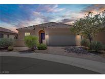 Charming single-story home featuring a two-car garage and well-manicured landscaping at 589 Via Paladini, Henderson, NV 89011
