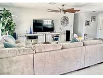 Spacious living room featuring a large sectional sofa and entertainment center at 6309 Miraloma St, Las Vegas, NV 89108