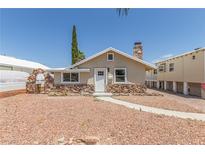 Charming single-story home with a unique stone facade and inviting walkway at 659 D Ave, Boulder City, NV 89005