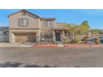 Charming two-story home featuring an attached garage, neutral stucco, and a landscaped front yard at 6804 Tropicaire St, Las Vegas, NV 89149