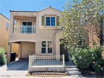Inviting two-story home featuring a charming front porch and balcony, plus an attached two-car garage at 7469 Margollini St, Las Vegas, NV 89148