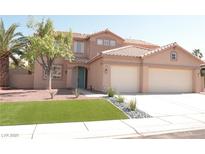 Charming two-story home featuring a tile roof, three-car garage and manicured front yard, creating a welcoming curb appeal at 825 Cornerstone Pl, North Las Vegas, NV 89031