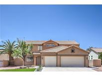 Charming two-story home featuring a desert landscape, tile roof, and a two-car garage at 825 Cornerstone Pl, North Las Vegas, NV 89031