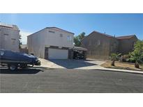Two-story home featuring an attached two-car garage and a front yard at 845 Bladensburg St, Las Vegas, NV 89110