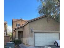 Charming two-story home featuring a two-car garage and neutral exterior paint, nestled under a clear blue sky at 8952 College Green St, Las Vegas, NV 89148