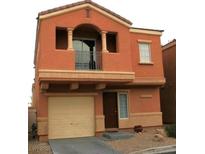 Two-story home features a two-car garage, a front balcony, and desert landscaping at 9402 Crimson Sky St, Las Vegas, NV 89178