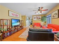 Inviting living room featuring hardwood floors, comfortable seating, and decorative wall art at 10203 Arlington Abby St, Las Vegas, NV 89183