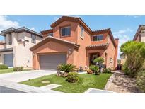 Charming two-story home featuring a well-manicured lawn, two-car garage and tasteful desert landscaping at 174 Augusta Course Ave, Las Vegas, NV 89148