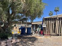 Exterior shot of home with fenced front yard and mature landscaping on a bright, sunny day at 1955 Raindance Way, Las Vegas, NV 89169