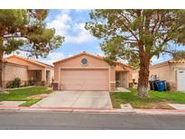 Charming single-story home with a two-car garage, desert landscaping, and a cozy front porch at 2104 Kendall Hill Ave, Las Vegas, NV 89106