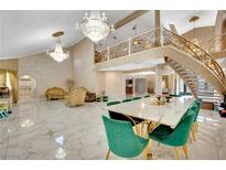 Spacious living room with marble floors, a grand staircase, and ornate chandeliers at 2131 Diamond Bar Dr, Las Vegas, NV 89117