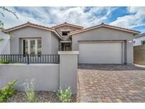 Charming single-story home featuring a brick driveway, two-car garage, stone accents, and desert landscaping at 2194 Pigeon Hawk St, Las Vegas, NV 89138
