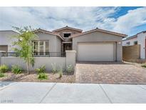 Charming single-story home with neutral stucco, stone accents, brick driveway, and two-car garage at 2194 Pigeon Hawk St, Las Vegas, NV 89138