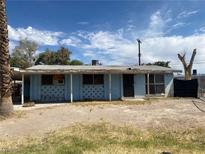 Modest single-story home featuring a light blue exterior, covered porch, and desert landscaping at 2642 San Vincente Ct, Las Vegas, NV 89115