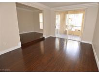 Open living room with wood floors and sliding glass doors to outdoor balcony at 270 E Flamingo Rd # 107, Las Vegas, NV 89169