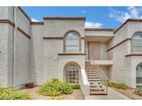 Charming condo featuring stucco siding, stairway access, and desert landscaping at 3150 Soft Breezes Dr # 1040, Las Vegas, NV 89128