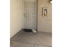Entry to unit #1040 showing security door, welcome mat, and wall-mounted fire extinguisher box at 3150 Soft Breezes Dr # 1040, Las Vegas, NV 89128