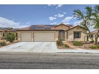 Charming single-story home featuring a desert landscape, solar panels, and a two-car garage at 3220 W Hammer Ln, North Las Vegas, NV 89031
