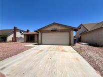Single-story home featuring a two-car garage and low maintenance landscaping at 4766 Knollwood Dr, Las Vegas, NV 89147