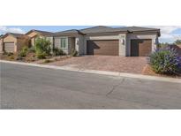 Charming single-story home featuring a spacious three-car garage and landscaped front yard at 5357 Eleganza Ave, Pahrump, NV 89061