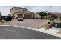 Charming two-story home with desert landscaping and a spacious driveway, perfect for multiple vehicles at 6311 Baker Creek St, Las Vegas, NV 89149