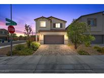 Charming two-story home featuring a well-maintained exterior, desert landscaping, and a paved driveway at 8261 Selenite St, Las Vegas, NV 89113