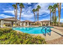 Resort style pool area with tropical landscaping and cabanas with ample seating for residents to enjoy at 9621 Donner Springs Ave, Las Vegas, NV 89148
