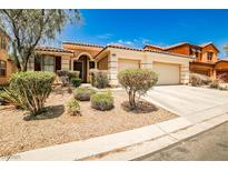 Charming single story home featuring a tile roof, a two car garage, and desert landscaping at 9987 Shiloh Heights St, Las Vegas, NV 89178