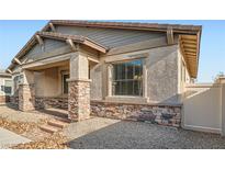 Charming single-story home with stone accents, stucco exterior, and well-maintained landscaping at 208 Coltrane Canyon Ave, Henderson, NV 89011